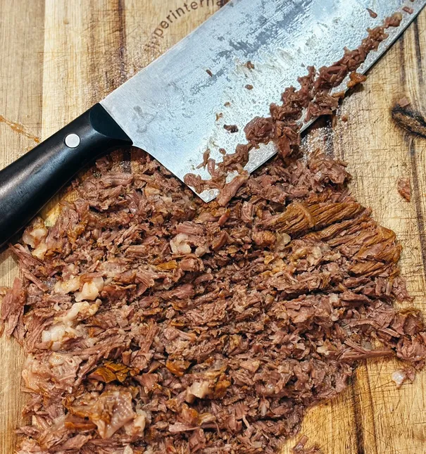 Slow cooked birria, a signature dish at The Birria Society in The Woodlands, TX.